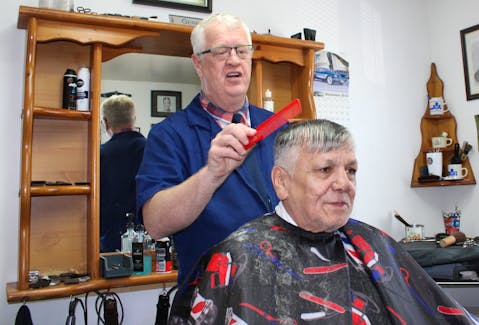 Gerry Rendell, left, cuts the hair of Gerry Aucoin, on Thursday morning at John’s Barber Shop. Rendell is retiring on Friday and made Aucoin one of his last customers. GREG MCNEIL/CAPE BRETON POST