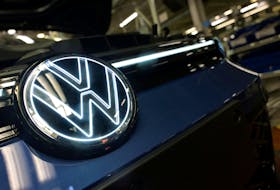 Volkswagen logo is illuminated on a production line for the Golf VIII and Tiguan cars at the VW headquarters in Wolfsburg, Germany May 23, 2024.