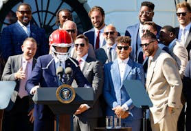 U.S. President Joe Biden wears a helmet gifted to him by the Kansas City Chiefs as he welcomes them to the White House to celebrate their championship season and victory in Super Bowl LVIII, in Washington, U.S., May 31, 2024.
