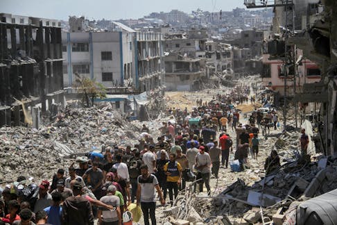 Palestinians make their way as they inspect the damages after Israeli forces withdrew from a part of Jabalia refugee camp, following a raid, in the northern Gaza Strip, May 30, 2024.
