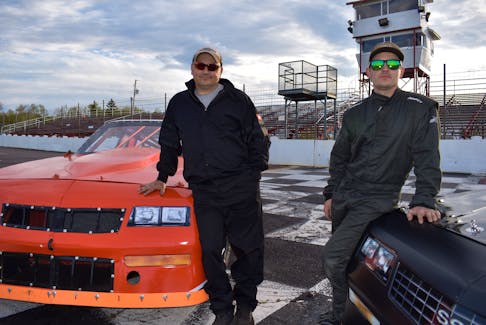J.J. Cusack, left, and son Dyllan Farrell stand beside their cars near the finish line at Bud’s Speedway in Sydney on Thursday. For the first time in their racing careers, Cusack and Farrell will race against each other in the street stock class this season with the first race set for Sunday afternoon. JEREMY FRASER/CAPE BRETON POST