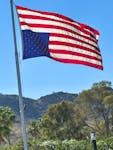 An inverted American flag flutters at the home of Don Tapia, a Trump donor and his former ambassador to Jamaica, in Paradise Valley, Arizona, U.S., on May 30, 2024, after the Republican presidential candidate and former U.S. President Donald Trump was found guilty in his criminal trial over charges that he falsified business records to conceal money paid to silence porn star Stormy Daniels in 2016. Don Tapia/Handout via REUTERS