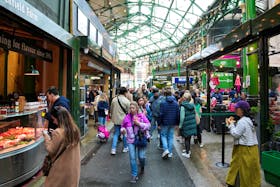 People walk past food stands and market stalls in a Borough Market in London, Britain May 22, 2024.