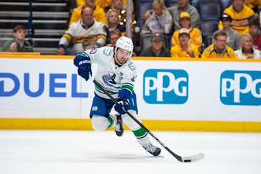 May 3, 2024; Nashville, Tennessee, USA; Vancouver Canucks defenseman Quinn Hughes (43) skates with the puck against the Nashville Predators during the second period in game six of the first round of the 2024 Stanley Cup Playoffs at Bridgestone Arena. Mandatory Credit: Steve Roberts-USA TODAY Sports