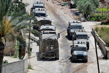 Israeli military vehicles are seen during an Israeli raid in Deir al-Ghusun, in the Israeli occupied West Bank, May 4, 2024.