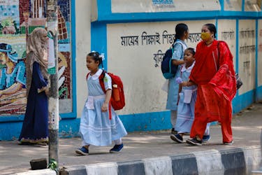 Children go to school as schools reopen after the fall in temperature, in Dhaka, Bangladesh, May 5, 2024.