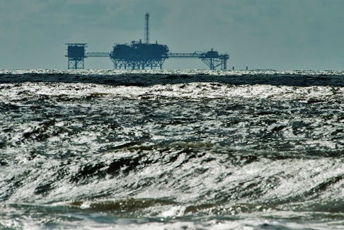 An oil and gas drilling platform stands offshore near Dauphin Island, Alabama, October 5, 2013. 