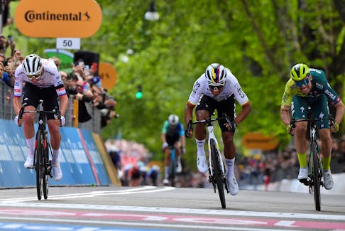 Cycling - Giro d'Italia - Stage 1 - Venaria Reale to Torino - Italy - May 4, 2024 Ineos Grenadiers's Jhonatan Narvaez crosses the finish line to win stage 1 followed by UAE Team Emirates' Tadej Pogacar