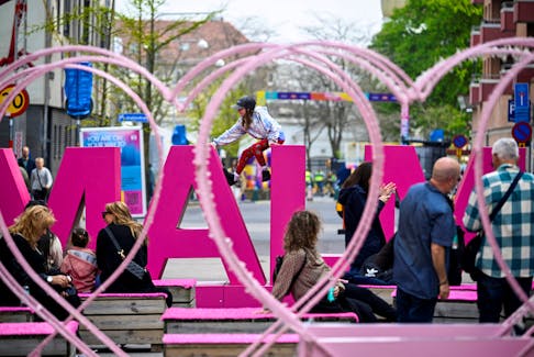A child sits on a sign, ahead of the Eurovision Song Contest, in Malmo, Sweden May 4, 2024.  TT News Agency/Johan Nilsson/via