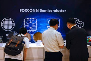 Foxconn shareholders look at wafers on display after the annual shareholder meeting in New Taipei City, Taiwan May 31, 2023.