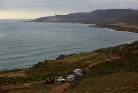 Members of a rescue team and forensic technicians work at a site where three bodies were found in the state of Baja California where one American and two Australian tourists were reported missing, in La Bocana, Mexico May 3, 2024.