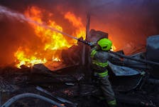 A firefighter works at a site a Russian missile strike, amid Russia's attack on Ukraine, in Kharkiv, Ukraine May 4, 2024.