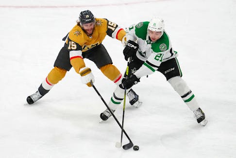 May 3, 2024; Las Vegas, Nevada, USA; Vegas Golden Knights defenseman Noah Hanifin (15) tips the puck away from Dallas Stars left wing Jason Robertson (21) during the third period of game six of the first round of the 2024 Stanley Cup Playoffs at T-Mobile Arena. Mandatory Credit: Stephen R. Sylvanie-USA TODAY Sports