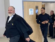 Tyreece Alexander Whynder-Ewing follows defence lawyer Chris Avery out of Nova Scotia Supreme Court in Dartmouth on Monday during a break at his trial on a charge of second-degree murder.