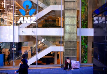 A man who says he is been homeless for over 30 years begs for money as he sits outside a branch of the ANZ Banking Group in central Sydney, Australia, July 18, 2017.