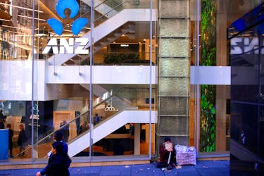 A man who says he is been homeless for over 30 years begs for money as he sits outside a branch of the ANZ Banking Group in central Sydney, Australia, July 18, 2017.
