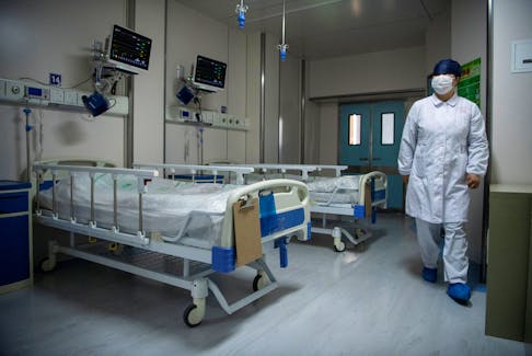 A nurse walks inside a quarantine room for coronavirus patients at finished but still unused building A2 of the Shanghai Public Clinical Center, in Shanghai, China February 17, 2020. Noel Celis/Pool via REUTERS