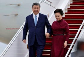 China's President Xi Jinping holds the hand of his wife Peng Liyuan as they disembark from their aeroplane upon their arrival for an official two-day state visit, at Orly airport, south of Paris, France on May 5, 2024. STEPHANE DE SAKUTIN/Pool via REUTERS