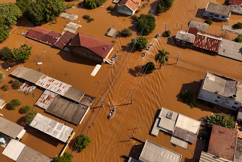 A drone view shows boats with volunteers searching for people isolated at houses, at the flooded neighborhood of Mathias Velho in Canoas, at the Rio Grande do Sul state, Brazil, May 5, 2024.