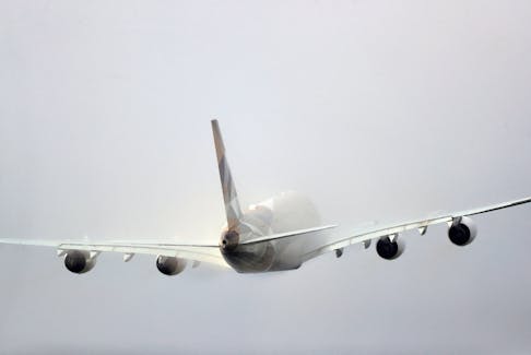 An Etihad aircraft disappears into the clouds as it takes off from Heathrow Airport in London, Britain March 14, 2020.