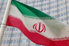 The Iranian flag flutters outside the International Atomic Energy Agency (IAEA) headquarters in Vienna, Austria, March 6, 2023.