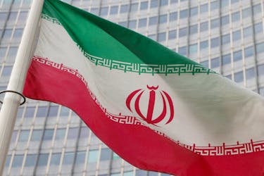 The Iranian flag flutters outside the International Atomic Energy Agency (IAEA) headquarters in Vienna, Austria, March 6, 2023.