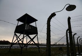 A wooden guard tower is pictured at the site of former Nazi German concentration and extermination camp Auschwitz II-Birkenau during ceremonies marking the 77th anniversary of the liberation of the camp and International Holocaust Victims Remembrance Day, in Brzezinka near Oswiecim, Poland January 27, 2022. Jakub Porzycki/Agencja Wyborcza.pl via