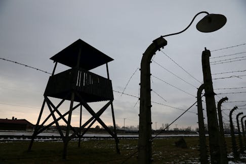 A wooden guard tower is pictured at the site of former Nazi German concentration and extermination camp Auschwitz II-Birkenau during ceremonies marking the 77th anniversary of the liberation of the camp and International Holocaust Victims Remembrance Day, in Brzezinka near Oswiecim, Poland January 27, 2022. Jakub Porzycki/Agencja Wyborcza.pl via