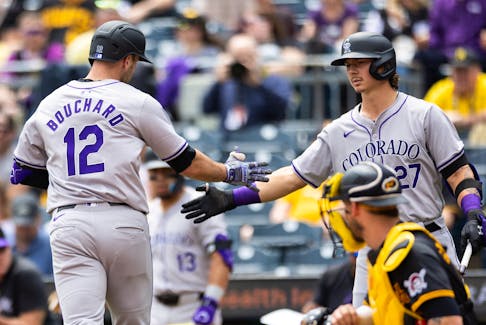 May 5, 2024; Pittsburgh, Pennsylvania, USA;  Colorado Rockies right fielder Sean Bouchard (12) is congratulated by left fielder Jordan Beck (27) following his solo home run against the Pittsburgh Pirates during the second inning at PNC Park. Mandatory Credit: Scott Galvin-USA TODAY Sports
