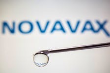 A Novavax logo is reflected in a drop on a syringe needle in this illustration taken November 9, 2020.