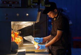 An employee cooks fries at a restaurant of the Vkusno & tochka fast food chain, the Russian successor brand to McDonald's, in Moscow, Russia March 1, 2023.