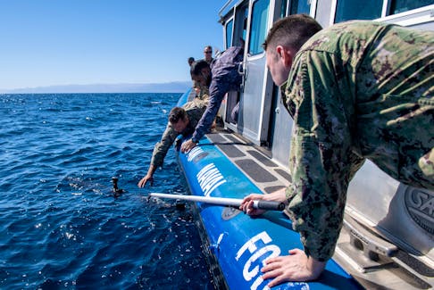 Sailors assigned to Task Force 59 and members of the Royal Jordanian Navy retrieve an Iver unmanned undersea vehicle during a 60-nation International Maritime Exercise/Cutlass Express 2022 (IMX/CE22), in the Gulf of Aqaba, Jordan, in this photo taken on February 8, 2022 and released by the U.S. Navy on February 10, 2022, U.S. Naval Forces Central Command/2nd Class Dawson Roth/Handout via