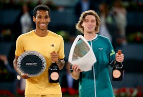 Tennis - Madrid Open - Park Manzanares, Madrid, Spain - May 5, 2024  Russia's Andrey Rublev poses with the trophy and runner up Canada's Felix Auger Aliassime after winning the final match