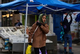 A woman walks through Surrey Street market in Croydon, south London, Britain, February 26, 2024.