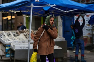 A woman walks through Surrey Street market in Croydon, south London, Britain, February 26, 2024.