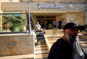 A man maneuvers media equipment following an Israeli police raid on an Al Jazeera de facto office at the Ambassador Hotel in Jerusalem, May 5, 2024.