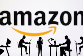Figurines with computers and smartphones are seen in front of Amazon logo in this illustration taken, February 19, 2024.