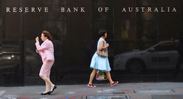 Two women walk next to the Reserve Bank of Australia headquarters in central Sydney, Australia February 6, 2018.