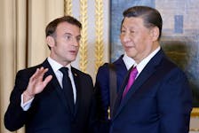 French President Emmanuel Macron and Chinese President Xi Jinping speak as they attend an official state dinner as part of the Chinese president's two-day state visit to France, at the Elysee Palace in Paris, France, May 6, 2024.  Ludovic Marin/Pool via