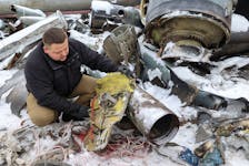 A representative from the prosecutor's office shows parts of an unidentified missile, which Ukrainian authorities believe to be made in North Korea and was used in a strike in Kharkiv earlier this week, amid Russia's attack on Ukraine, in Kharkiv, Ukraine January 6, 2024.