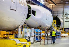 An employee walks past a fuselage section under construction at Boeing Co.'s 787 Dreamliner campus in North Charleston, South Carolina, U.S., May 30, 2023. Gavin McIntyre/Pool via