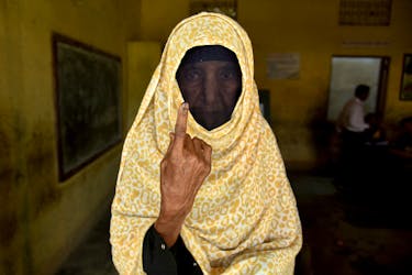 A woman shows her ink-marked finger after casting her vote at a polling station during the second phase of the general election in Nagaon district in the northeastern state of Assam, India, April 26, 2024.