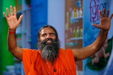 Indian yoga guru Baba Ramdev gestures as talks to media after a news conference in New Delhi, India, May 4, 2017. To match Special Report INDIA-MODI/RAMDEV