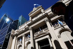 A man walks past the facade of Argentina's Central Bank, one day after the inauguration of Argentina's President Javier Milei and his Vice President Victoria Villarruel, in Buenos Aires, Argentina, December 11, 2023.