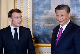 French President Emmanuel Macron and Chinese President Xi Jinping speak as they attend an official state dinner as part of the Chinese president's two-day state visit to France, at the Elysee Palace in Paris, France, May 6, 2024. Ludovic Marin/Pool via REUTERS