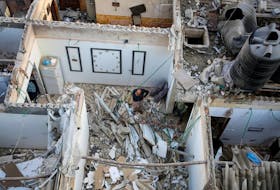Palestinians inspect a house damaged in an Israeli strike, amid the ongoing conflict between Israel and the Palestinian Islamist group Hamas, in Rafah, in the southern Gaza Strip May 7, 2024.