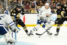 May 4, 2024; Boston, Massachusetts, USA; Boston Bruins defenseman Charlie McAvoy (73) tries to control the puck while Toronto Maple Leafs defenseman Simon Benoit (2) defends during the third period in game seven of the first round of the 2024 Stanley Cup Playoffs at TD Garden. Mandatory Credit: Bob DeChiara-USA TODAY Sports/File Photo