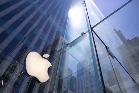 FILE - In this June 16, 2020 file photo, the sun is reflected on Apple's Fifth Avenue store in New York. 