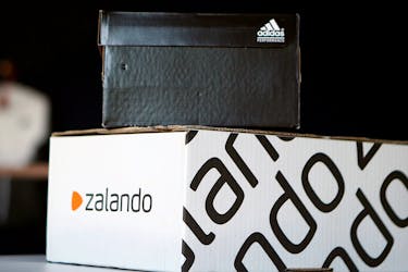 A Adidas shoebox stands above a Zalando cardboard box on a staged scene in Berlin, Germany June 8, 2016.