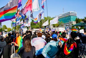 Members of the LGBTQ+ community march in front of the new Presidential office during a protest ahead of the International Day Against Homophobia, Transphobia and Biphobia, in Seoul, South Korea, May 14, 2022. 